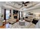 Cozy living room featuring a stone fireplace, hardwood flooring and coffered ceilings at 2640 Paddock Point Pl, Dacula, GA 30019