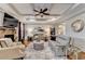 Spacious living room with a cozy stone fireplace and coffered ceilings at 2640 Paddock Point Pl, Dacula, GA 30019