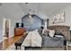Serene bedroom featuring custom paneled wall, hardwood floors and a lavish bed at 2640 Paddock Point Pl, Dacula, GA 30019