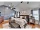 Large main bedroom with stylish accent wall, hardwood floors and seating at 2640 Paddock Point Pl, Dacula, GA 30019