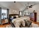 Spacious main bedroom with sitting area, ceiling fan, and hardwood floors at 2640 Paddock Point Pl, Dacula, GA 30019