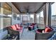 Screened-in porch with comfortable wicker furniture for relaxed outdoor living at 2640 Paddock Point Pl, Dacula, GA 30019