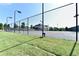 Community tennis court with lighting for evening play at 2640 Paddock Point Pl, Dacula, GA 30019