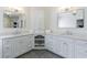 Bright bathroom featuring double sinks, marble countertops, vanity, and a tile floor at 350 Newcastle Dr, Alpharetta, GA 30009