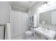 Classic bathroom with a pedestal sink, white tile floors, and a shower with a curtain at 350 Newcastle Dr, Alpharetta, GA 30009