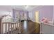 Bright Bedroom featuring hardwood floors, tray ceiling, and lavender walls at 350 Newcastle Dr, Alpharetta, GA 30009