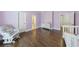Well-lit Bedroom featuring hardwood floors, a rocking chair, and access to an adjoining bathroom at 350 Newcastle Dr, Alpharetta, GA 30009