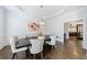 Dining room with hardwood floors, white trim, and a modern chandelier at 350 Newcastle Dr, Alpharetta, GA 30009