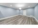 Unfurnished room with light blue walls, white trim, and wood-look flooring at 350 Newcastle Dr, Alpharetta, GA 30009