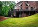 Exterior view of the home showcasing the deck and beautifully maintained lawn at 350 Newcastle Dr, Alpharetta, GA 30009