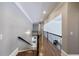 Elegant hallway with hardwood floors and views to the lower level and second floor at 350 Newcastle Dr, Alpharetta, GA 30009