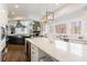Gourmet kitchen featuring an island, stainless appliances, and a stone fireplace at 350 Newcastle Dr, Alpharetta, GA 30009