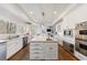 Elegant kitchen featuring stainless steel appliances, custom cabinets and a large island at 350 Newcastle Dr, Alpharetta, GA 30009