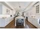 Bright and spacious kitchen with white cabinets, large island, and hardwood floors at 350 Newcastle Dr, Alpharetta, GA 30009