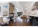 Open floor plan kitchen next to breakfast nook with stone fireplace, hardwood floors, and lots of natural light at 350 Newcastle Dr, Alpharetta, GA 30009