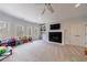 Spacious living room with a cozy fireplace, built-in shelving, and large windows at 350 Newcastle Dr, Alpharetta, GA 30009