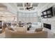 Sunken living room with coffered ceiling, fireplace, built-ins and large curved windows at 350 Newcastle Dr, Alpharetta, GA 30009