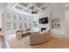 Sunken living room with coffered ceiling, fireplace, built-ins and large curved windows at 350 Newcastle Dr, Alpharetta, GA 30009
