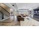 Open-concept living room with modern lighting, a stylish rug, and a staircase view at 350 Newcastle Dr, Alpharetta, GA 30009