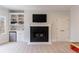 Bright living room features a cozy fireplace, built-in shelves, and a mini fridge at 350 Newcastle Dr, Alpharetta, GA 30009