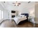 This bedroom features a fireplace, built-in bookshelves, and a tray ceiling with ceiling fan at 350 Newcastle Dr, Alpharetta, GA 30009