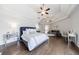 Comfortable bedroom boasts hardwood floors, tray ceiling, a ceiling fan, sitting area, and fireplace at 350 Newcastle Dr, Alpharetta, GA 30009