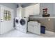 Mud room featuring a side-by-side washer and dryer and access to the backyard at 350 Newcastle Dr, Alpharetta, GA 30009