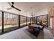 Covered patio with ceiling fans, stone table and chairs overlooks large, private backyard at 350 Newcastle Dr, Alpharetta, GA 30009