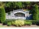Stone entrance sign for Harrington Falls community amid lush landscaping at 350 Newcastle Dr, Alpharetta, GA 30009