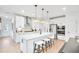 Modern kitchen features white cabinets, quartz countertops, stainless steel appliances, and an island with seating at 5765 Tillman Way, Powder Springs, GA 30127