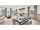 Open-concept living area featuring a dining table and large windows offering natural light and views at 5765 Tillman Way, Powder Springs, GA 30127