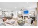 Spacious open-concept living room featuring a cozy fireplace, modern lighting, and seamless flow into the kitchen at 5765 Tillman Way, Powder Springs, GA 30127