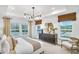 Serene main bedroom features a tray ceiling, neutral tones, natural light, and a sophisticated, calm ambiance at 5765 Tillman Way, Powder Springs, GA 30127