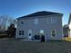 View of backyard, showing patio and two story house with a dark roof at 101 Waters Edge Pkwy, Temple, GA 30179