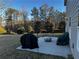 View of backyard showing the patio with grill and assorted trees and plants at 101 Waters Edge Pkwy, Temple, GA 30179