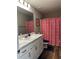 Bathroom featuring white cabinet, laminate floor, and pink Barbie shower curtain at 101 Waters Edge Pkwy, Temple, GA 30179