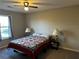 Bedroom with ceiling fan, lamps, and patterned quilt at 101 Waters Edge Pkwy, Temple, GA 30179