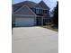 Charming two-story home featuring a two-car garage, manicured lawn, and classic design at 101 Waters Edge Pkwy, Temple, GA 30179