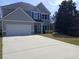 Charming two-story home featuring a two-car garage, manicured lawn, and classic design at 101 Waters Edge Pkwy, Temple, GA 30179