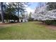 Spacious backyard with mature trees and flowering bushes, offering a private and serene outdoor space at 1316 Milstead Ave, Conyers, GA 30012