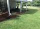 Manicured backyard featuring a patio, brick accents, and lush green lawn at 1316 Milstead Ave, Conyers, GA 30012