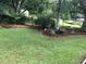 Backyard of home with green grass and shady trees at 1316 Milstead Ave, Conyers, GA 30012