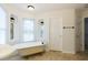 Bathroom featuring a vintage clawfoot tub, linen closet and decorative stained glass windows at 1316 Milstead Ave, Conyers, GA 30012