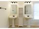 Bathroom featuring double sinks with matching pedestal sinks and mirrors at 1316 Milstead Ave, Conyers, GA 30012