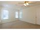 Spacious bedroom with neutral carpeting and a ceiling fan for comfort at 1316 Milstead Ave, Conyers, GA 30012