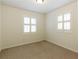 Bedroom with neutral carpet, plantation shutters, and ample natural light at 1316 Milstead Ave, Conyers, GA 30012