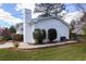 Attractive white home with lush landscaping, a brick foundation, and charming garden beds at 1316 Milstead Ave, Conyers, GA 30012