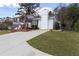 Well-maintained two-story home featuring a classic white exterior, spacious driveway, and manicured lawn at 1316 Milstead Ave, Conyers, GA 30012