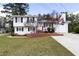 Charming split-level home featuring a manicured lawn, brick accents and a long driveway at 1316 Milstead Ave, Conyers, GA 30012