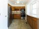 Charming kitchen with stainless steel appliances, wood cabinets and tiled backsplash at 1316 Milstead Ave, Conyers, GA 30012